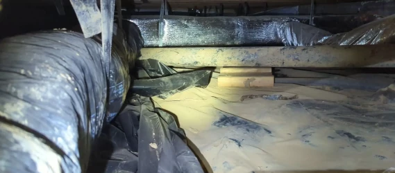 Crawlspace before repair showing dirt floor, debris and moisture issues prior to encapsulation or waterproofing.