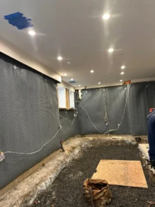 mid install of dimpled drainage mat-replaced plastic liner-optimized